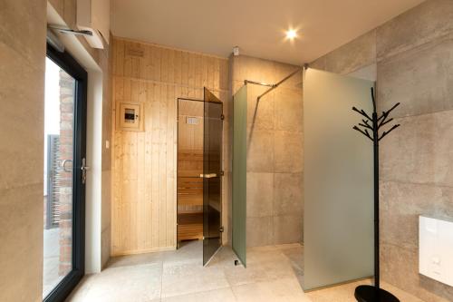 绿山城Apartamenty Centrum Park的带淋浴的浴室和玻璃门