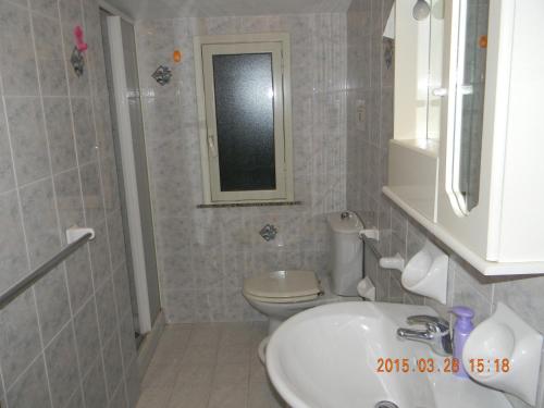 诺托玛丽娜Casa Concetta的一间带水槽、卫生间和镜子的浴室