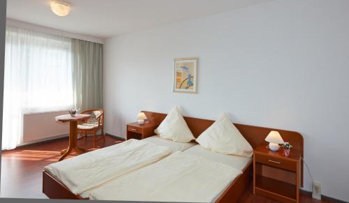莱比锡 - 勒塔阿尔法公寓酒店客房内的一张或多张床位