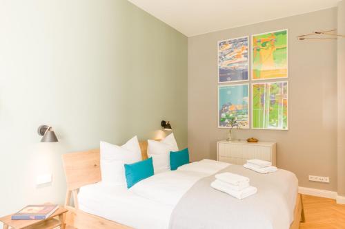 塞巴特阿尔贝克OSTKÜSTE - Nadler Hof Design Apartments的卧室配有白色的蓝色调床。