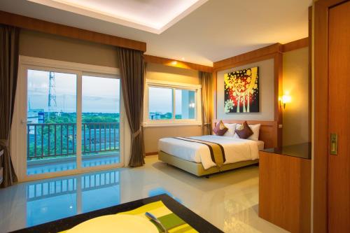 坤敬浪漫孔敬酒店的酒店客房设有一张床和一个阳台。