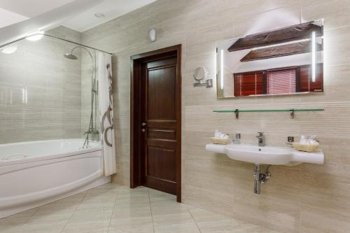 克拉斯诺达尔南塔酒店的浴室配有盥洗盆和浴缸。