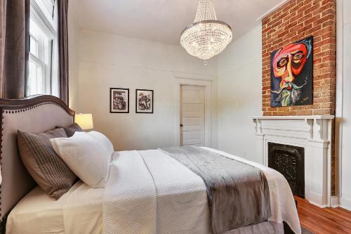新奥尔良Modern Victorian House With Relaxing Courtyard的一间卧室配有一张床和一个壁炉