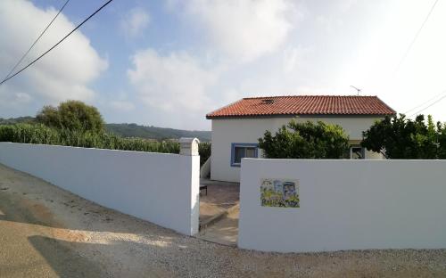 Cela VelhaCasinha d'Alice et Serge的房屋前的白色围栏