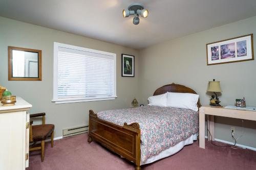 Islandale57 Mud Bay的一间卧室配有一张床、一张书桌和一个窗户。