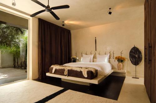 马拉喀什达尔萨布拉酒店的一间卧室设有一张大床和一个大窗户