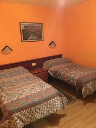 布尔戈斯希尔顿旅馆的橙色墙壁客房的两张床