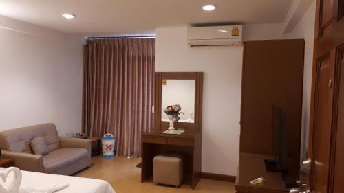 邦帕利Nut Mansion Suvarnabhumi的配有床、椅子和镜子的房间