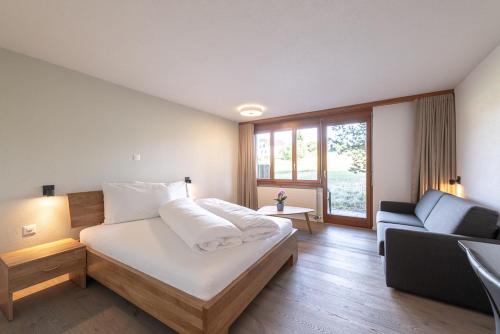 RütiNoah Hotel的一间卧室配有一张床和一个沙发