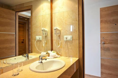 埃尔阿雷纳尔Hotel Ipanema Beach的一间带水槽和镜子的浴室