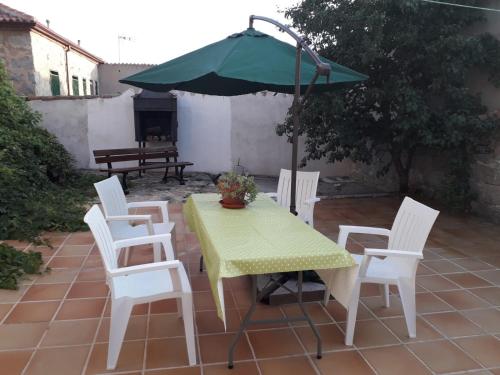 阿维拉Casa Luz的庭院内桌椅和遮阳伞