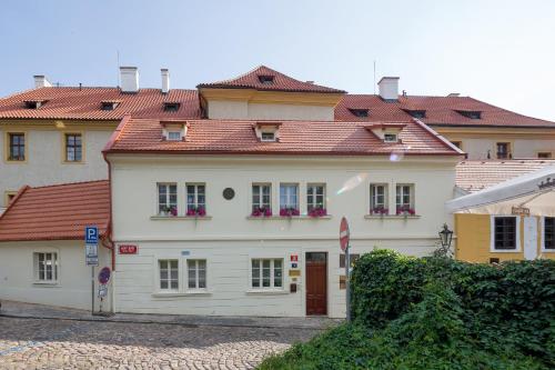 布拉格Aparthotel Tycho de Brahe的一间大型白色房屋,设有红色屋顶
