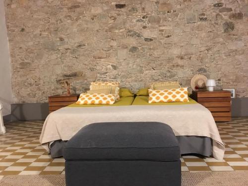 赫罗纳Priçosa Perfect Apart Cyclists&Travellers的一间卧室设有一张床和石墙