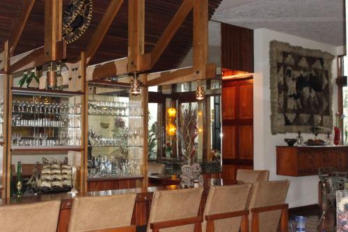 迦太基Casa Mora B&B的餐厅内的酒吧配有椅子和柜台