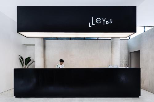 塞米亚克Lloyd's Inn Bali的站在大厅黑柜台后面的人