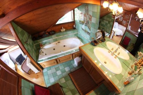 Villar-Saint-Pancrace皮革厂酒店的享有带浴缸和水槽的浴室的顶部景致。