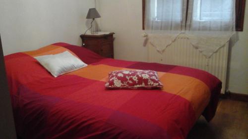 沙尼chez sylvie et jean-yves的一张色彩缤纷的床,上面有枕头