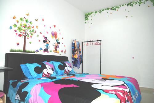 实兆远Qstay Sitiawan Townhouse (Minnie Dreams) - 米妮梦的卧室配有一张带米基老鼠床罩的床