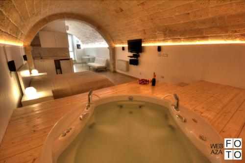 莫诺波利Suite Stone Luxury的卧室内设有一个大浴缸