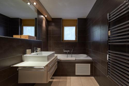 采尔马特Haus Bor的浴室配有盥洗盆和浴缸。
