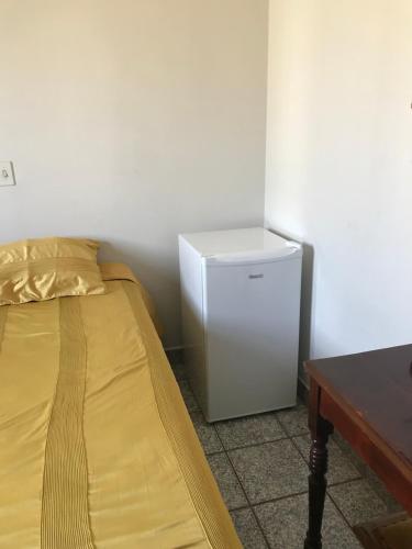 普雷图河畔圣若泽Espaco unico的配有床的客房内的小冰箱