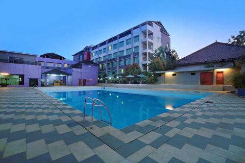 丹戎ASTON Tanjung City Hotel的大楼前的游泳池