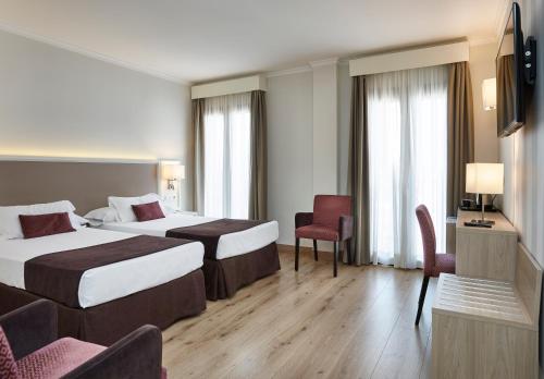 隆达梅斯特拉萨酒店的酒店客房设有两张床和电视。