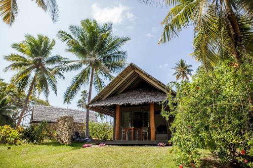 卢甘维尔奥雷岛度假村的前面有棕榈树的房子