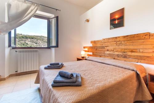 IrgoliRistoro Norghio的一间卧室配有一张大床和毛巾