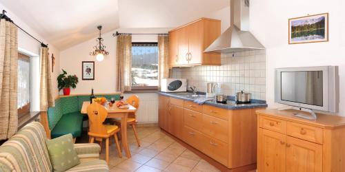 卡斯特尔罗托Apartment Gertrud的厨房配有桌子和电视。