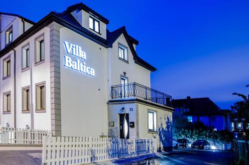 斯维诺乌伊希切Villa Baltica的白色的建筑,旁边标有标志