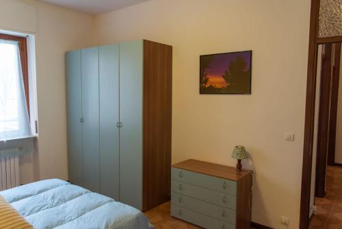亚历山德里亚Luminoso bilocale的一间卧室配有床、梳妆台和橱柜。