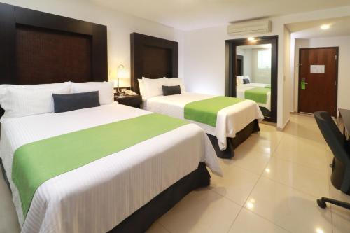瓜达拉哈拉阿库厄杜克托温德姆花园酒店客房内的一张或多张床位