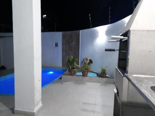 卡拉瓜塔图巴Sunny apartamentos de 1 e 2 dormitórios na Martin de Sá próximo a praia的一间带盆栽和游泳池的浴室