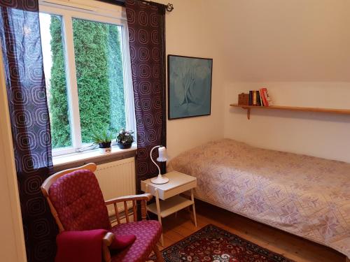 穆塔拉Perenner på bakgården的卧室配有床、椅子和窗户。