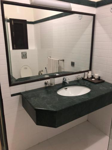 卡拉奇Sunset Suites的一间带水槽和大镜子的浴室