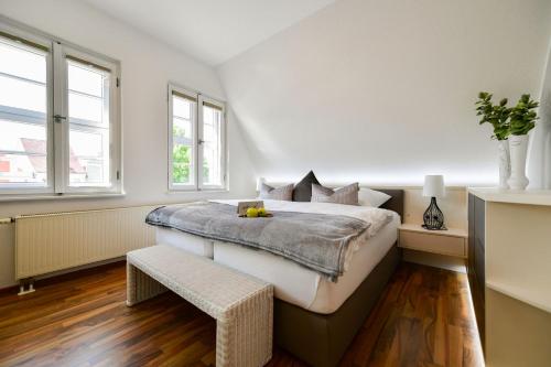 科特布斯Altstadt Apartment Deluxe的白色卧室设有一张大床和两个窗户