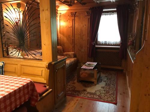 科尔蒂纳丹佩佐Sweet Home的一间卧室设有一张床、一个窗口和一张桌子