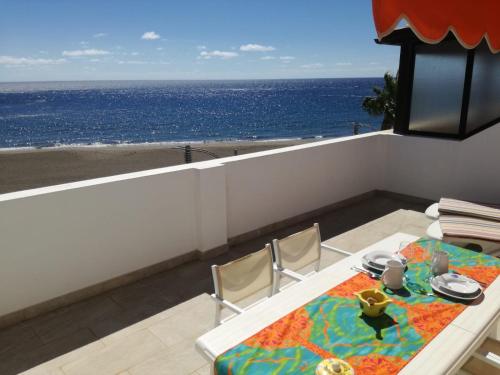 大塔拉哈尔ÁTICO EN PRIMERA LINEA DE PLAYA的一张桌子和椅子,享有海景