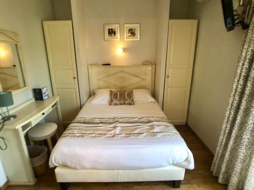 勒拉旺杜Hôtel Méditerranée的小卧室配有带钱包的床