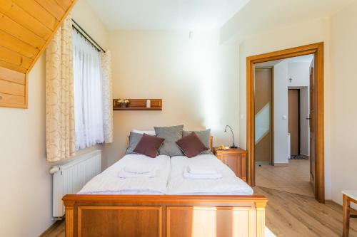 扎科帕内Rent like home - Krzeptówki的一间卧室配有一张带白色床单的木床