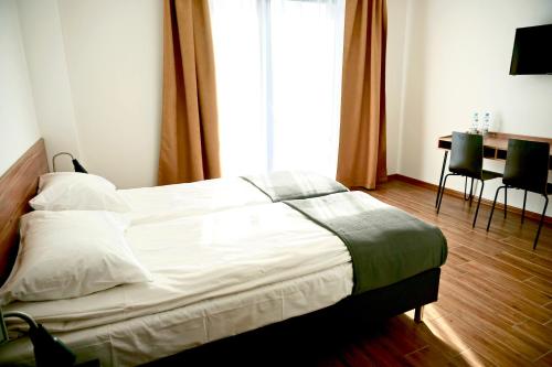 Simar客房内的一张或多张床位