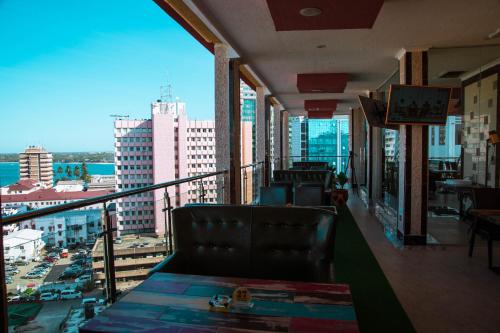 达累斯萨拉姆Tiffany Diamond Hotels LTD - Makunganya的一间享有城市美景的阳台的餐厅