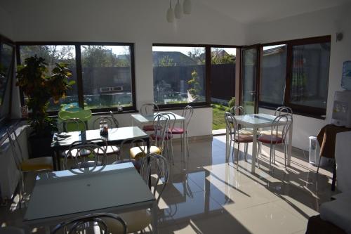 图尔达Pensiunea Casa Zece的客房设有桌椅和窗户。