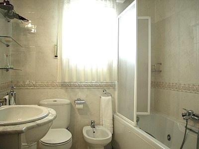 巴尔铁拉Casa Rural Sancho el Fuerte的白色的浴室设有水槽、卫生间和浴缸。