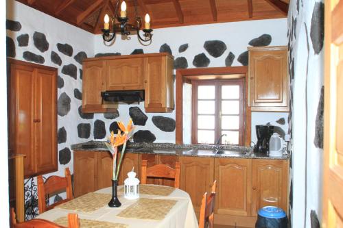 蒂哈拉费Casa Rural Los Abuelos的厨房配有带花瓶的桌子