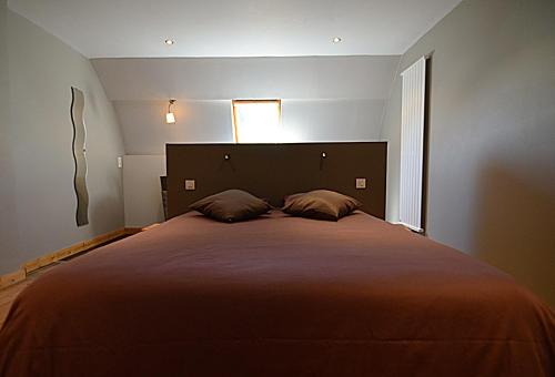 讷沙托La Citadine-Gîte citadin的一间卧室配有一张大床和两个枕头