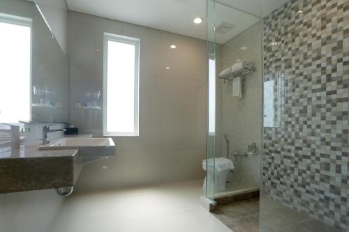 泗水泗水高级商务酒店的带淋浴、盥洗盆和卫生间的浴室