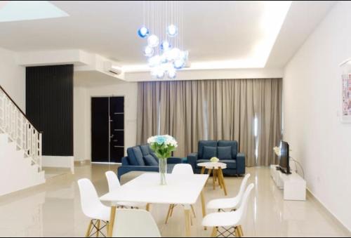 新山4-Bedrm ensuite family friendly house near Aeon Bukit Indah的客厅配有沙发和桌椅