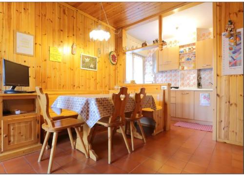 普雷达佐Casa Lulu'的厨房以及带桌椅的用餐室。